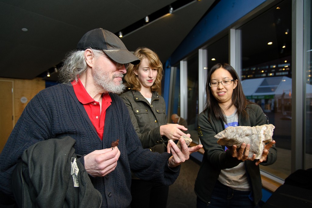 Graduate student Christine Chen (right) shows guests a stalagmite. The mineral is used to understand ancient climate. Credit: John Gillooly