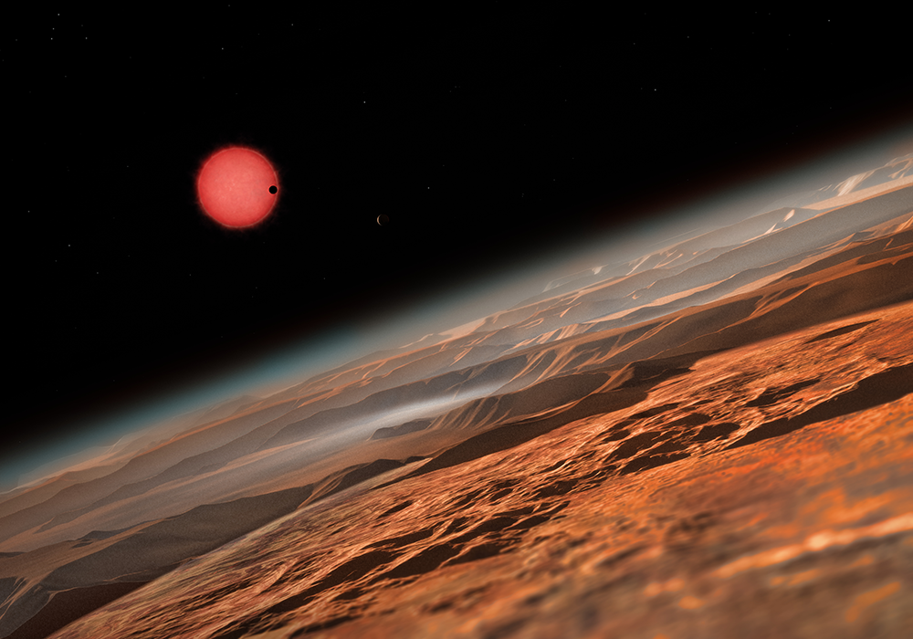 This artist’s impression shows an imagined view from close to one of the three planets orbiting an ultracool dwarf star just 40 light-years from Earth that were discovered using the TRAPPIST telescope at ESO’s La Silla Observatory. These worlds have sizes and temperatures similar to those of Venus and Earth and are the best targets found so far for the search for life outside the Solar System. They are the first planets ever discovered around such a tiny and dim star. In this view one of the inner planets is seen in transit across the disc of its tiny and dim parent star. (Credit: ESO/M. Kornmesser)