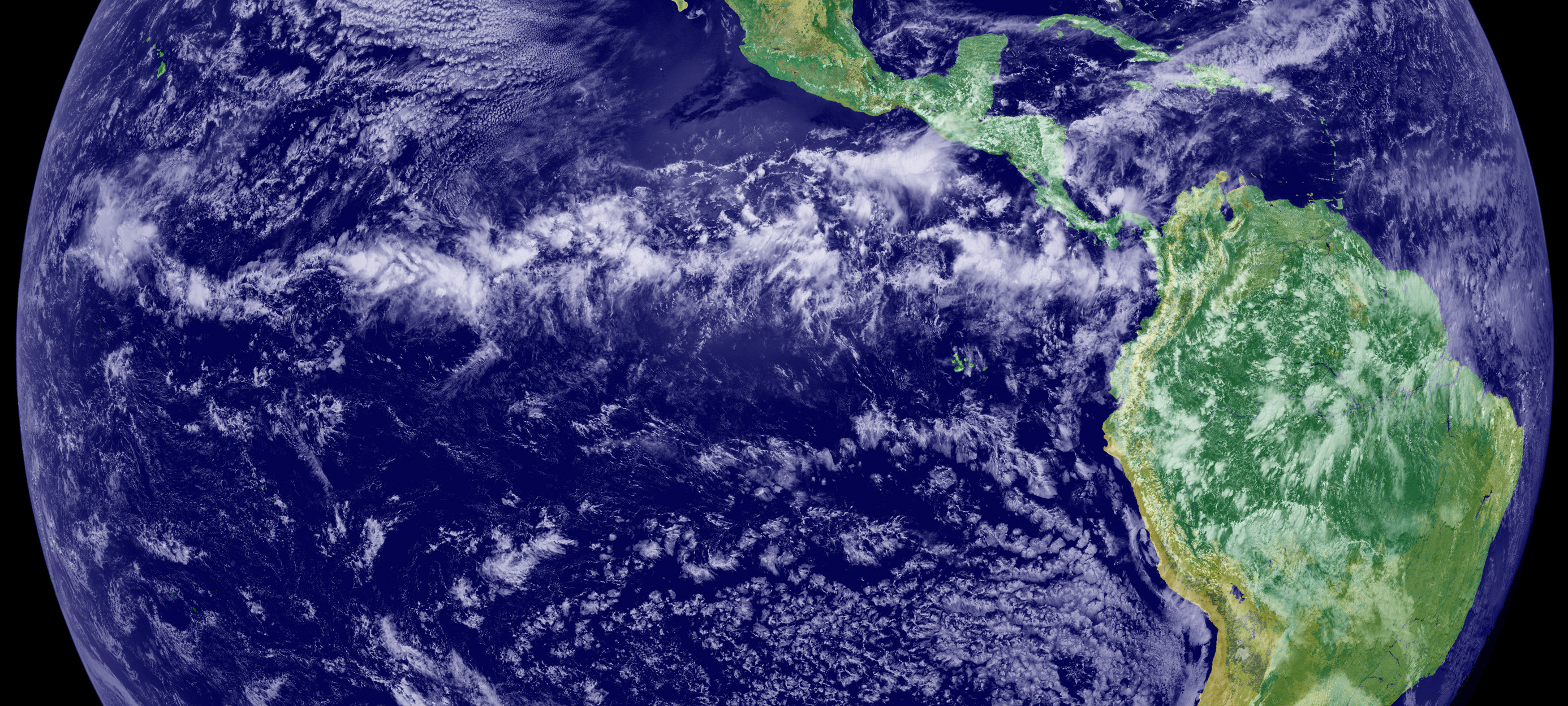 This image is a combination of cloud data from NOAA’s Geostationary Operational Environmental Satellite (GOES-11) and color land cover classification data. The ITCZ is the band of bright white clouds that cuts across the center of the Earth. (Photo: NOAA's GOES Project Science Office)