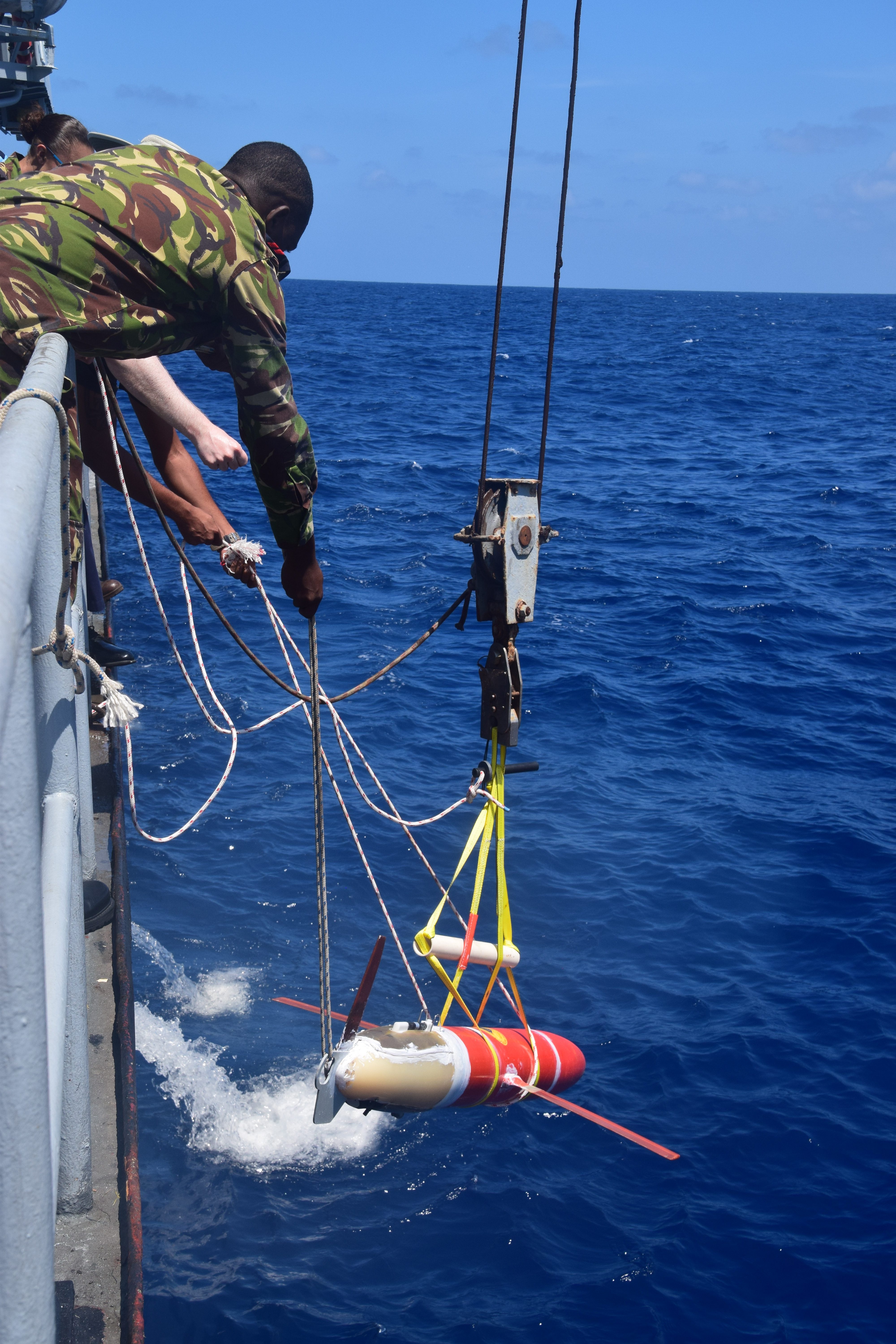 Releasing the glider into the water. (Photo: Joleen Heiderich, MIT/WHOI Joint Program)