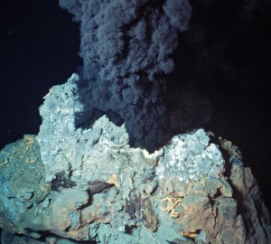 A black smoker chimney releases hydrothermal vent fluid. (Courtesy of WHOI Archives)
