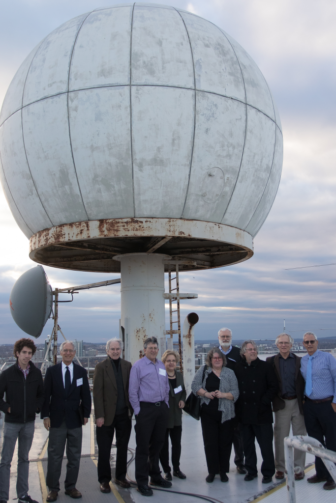 MIT friends, faculty and Austin family pose in front of a radome Polly helped install at MIT.