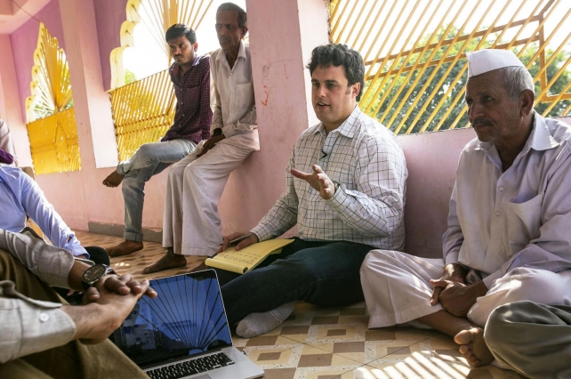 Amos Winter, assistant professor in the Department of Mechanical Engineering, speaks to individuals in India, where he has introduced assistive technologies such as a wheelchair for rugged terrain. (Photo: John Freidah/Department of Mechanical Engineering)
