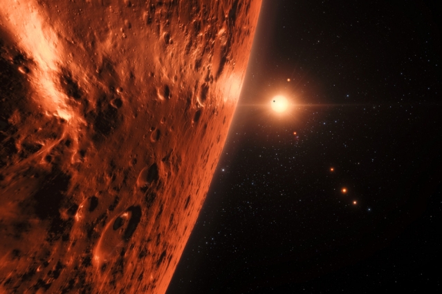 This artist’s impression shows the view from the surface of one of the planets in the TRAPPIST-1 system. At least seven planets orbit this ultracool dwarf star 40 light-years from Earth and they are all roughly the same size as the Earth. Several of the planets are at the right distances from their star for liquid water to exist on the surfaces. (Image: ESO/N. Bartmann/spaceengine.org)