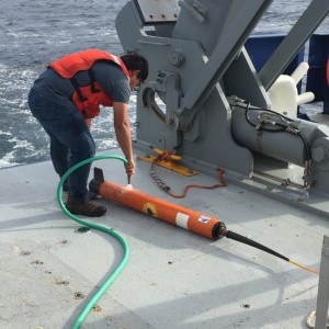 Washing seawater off of the magnetometer after recovery. (Photo by J.-A. Olive.)
