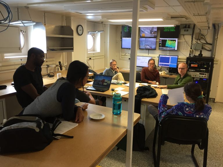 The science party gathered in the main lab, discussing gravimeter data. (Photo by J.-A. Olive.)