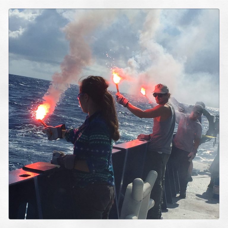 Students and crew members practice using handheld distress flares. (Photo by J.-A. Olive.)